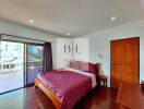 Spacious bedroom with balcony view