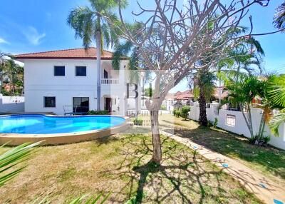 Two-story house with a pool and garden