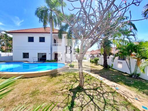 Two-story house with a pool and garden