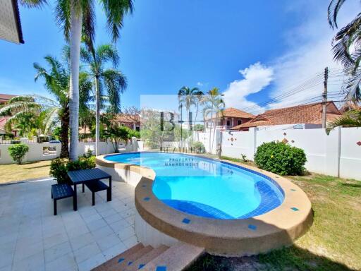 Outdoor swimming pool with seating area