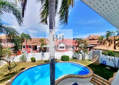 Backyard with swimming pool and palm trees