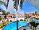 Backyard with swimming pool and palm trees