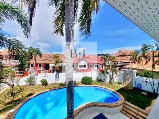 Backyard with swimming pool and palm trees