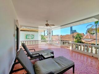 Spacious balcony with lounge chairs and city view