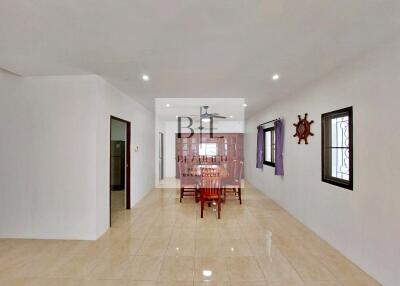 Spacious dining area with a wooden dining table set and nautical decor