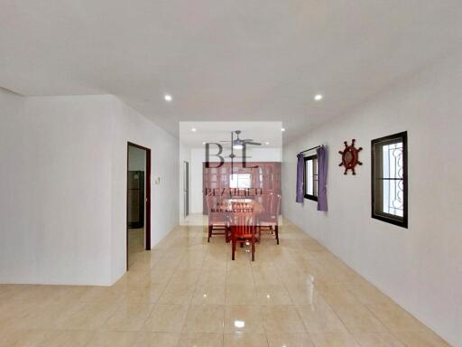 Spacious dining area with a wooden dining table set and nautical decor