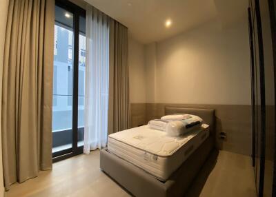 Modern bedroom with floor-to-ceiling windows and curtains