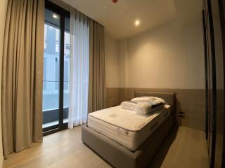 Modern bedroom with floor-to-ceiling windows and curtains