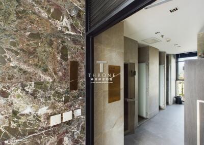 Modern building hallway with marble walls and access to rooms