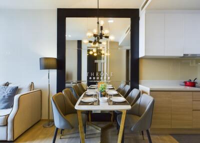 Modern dining area with a stylish table, chairs and a chandelier