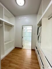 Spacious walk-in closet with hanging rods and shelving