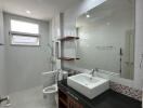 Modern bathroom with a large mirror and a white sink