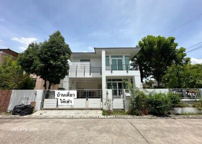 Modern two-story white house with balcony and driveway