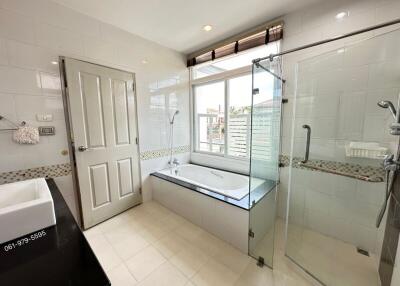 Modern bathroom with separate tub and glass shower enclosure