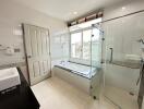 Modern bathroom with separate tub and glass shower enclosure