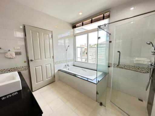 Modern bathroom with separate tub and glass shower enclosure