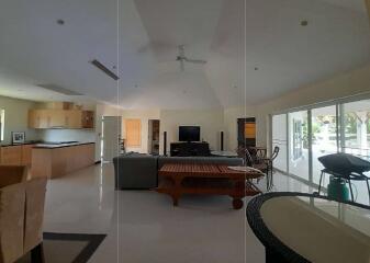 Spacious open-plan living room with kitchen and dining area