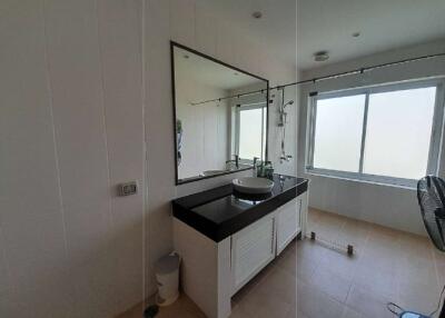 Modern bathroom with large mirror and natural light