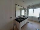 Modern bathroom with large mirror and natural light