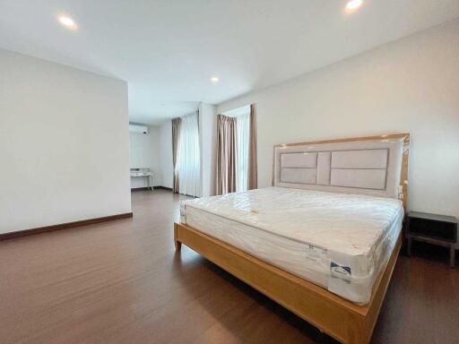 Spacious bedroom with large windows and ample natural light