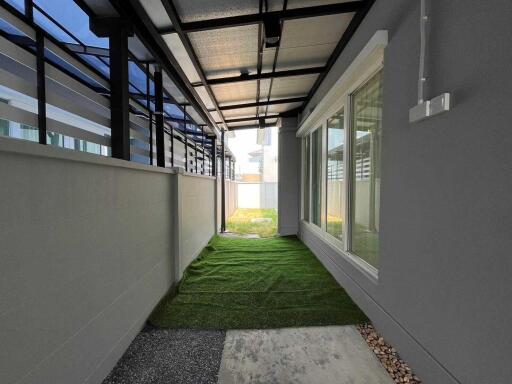 Covered outdoor corridor with artificial grass
