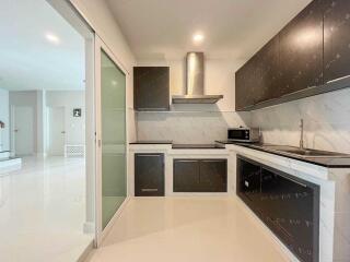 Modern kitchen with dark cabinets and stainless steel appliances