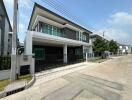 Modern two-story house with a gated driveway