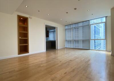 Spacious living room with hardwood flooring and large windows