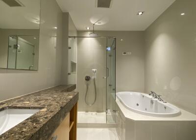 Modern bathroom with a bathtub and a glass-enclosed shower