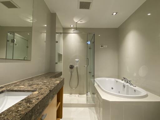 Modern bathroom with a bathtub and a glass-enclosed shower