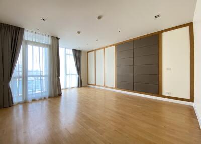 Spacious living room with large windows and wooden flooring