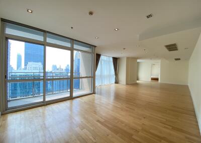 Spacious living area with large windows and city view