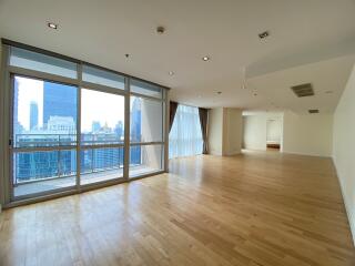 Spacious living area with large windows and city view