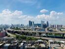 City skyline with road infrastructure under a blue sky