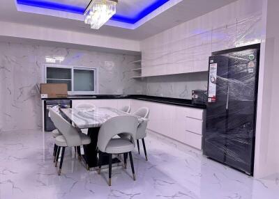 Modern kitchen with marble flooring and a dining area