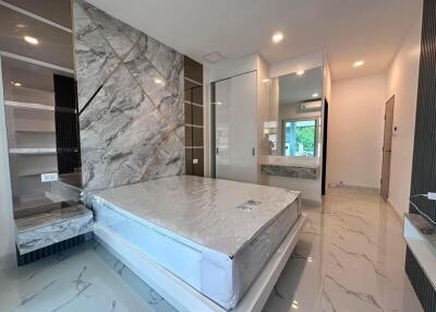 Modern bedroom with marble accents and large built-in wardrobe