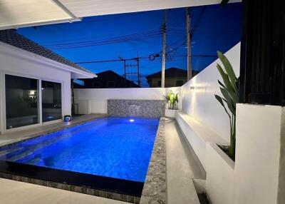 Outdoor pool with modern lighting and surrounding seating area