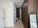 Spacious hallway with wooden flooring and built-in wooden cabinets