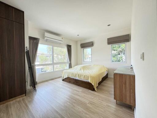 spacious bedroom with large windows and natural light