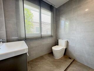 Modern bathroom with large window and sleek tiling