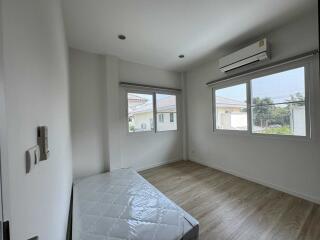 Minimalist bedroom with large windows and air conditioning