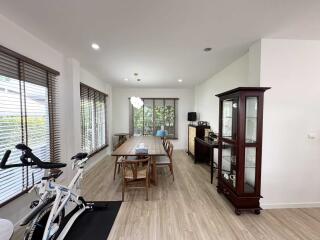 Spacious dining area with wooden floor and large windows