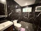 modern bathroom with black marble tiles