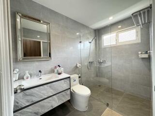 Modern bathroom with glass shower and large mirror