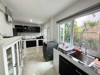 Modern kitchen with ample natural light and garden view