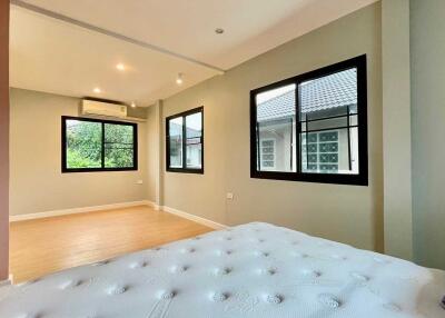 Spacious bedroom with large windows and natural light