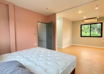 Spacious bedroom with adjoining area and large window