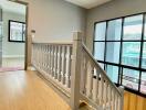 Bright hallway with wooden flooring and large windows