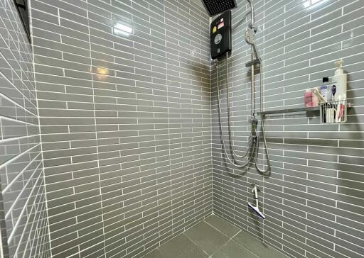 Modern bathroom with tiled walls and walk-in shower