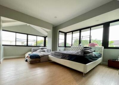 Spacious bedroom with large windows and two beds